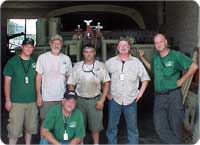 Vechicle restoration shop pose for our camera